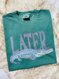 Green t-shirt with purple alligator graphic and 'LATER' gator text on a fur surface Alligator 