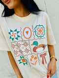 Person wearing a white t-shirt with colorful Antique Designs patterns and a mallard duck illustration.