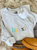 Ash sweatshirt with "Biloxi" on it in Muti color rainbow thread