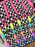 A stack of various Neon colored t-shirts with a checkered custom pattern MAMA.