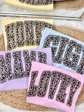 Set of towels with leopard print text on a textured surface