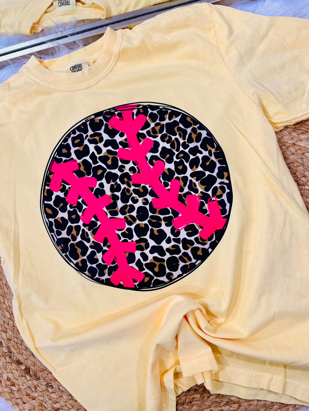 Yellow t-shirt with pink antlers on a leopard print background