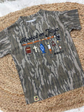 Camouflage t-shirt with fishing-themed Jesus design and text on a woven mat.