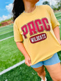 Person wearing a yellow t-shirt with 'PRCC Wildcats' text on a sports field.