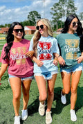 Three women wearing school spirit shirts on a sports field