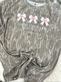 Mossy Oak Camouflage shirt with 'Dash Forward Boutique' text and pink bows on a white surface