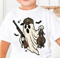 Child wearing a white t-shirt with a camo ghost holding a gun and two ducks design.